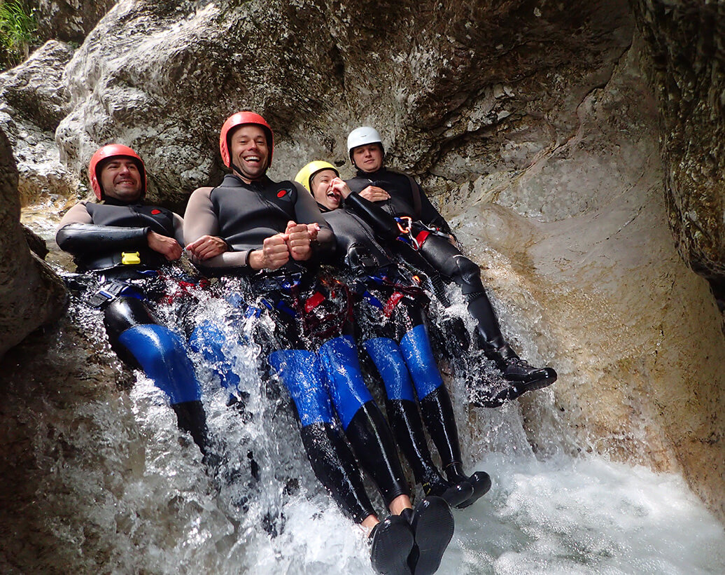 Canyoneers are enjoying playfull waterfalls in Sušec canyon, Bovec