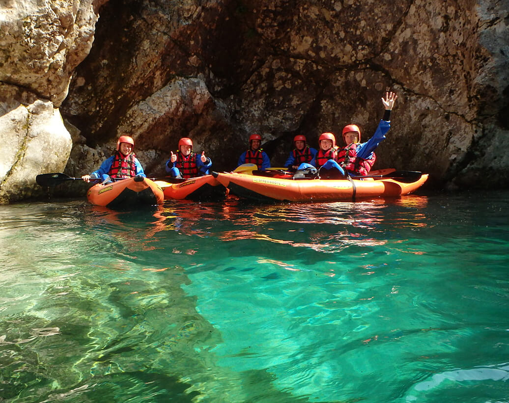 Whitewater Kayaking tour Soča river | Group of kayaker are in Zmuklica gorge of Soča river