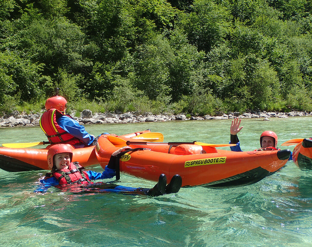Whitewater kayak tour, Slovenia | Kayakers are swimming in Soča river on kayak tour, Slovenia