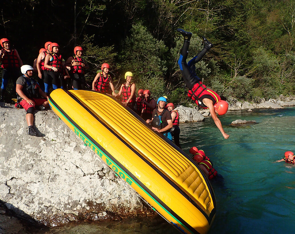 Rafting Slovenia Soča Bovec | Rafters are jumping on the raft boat on rafting tour, Soča, Bovec, Slovenia