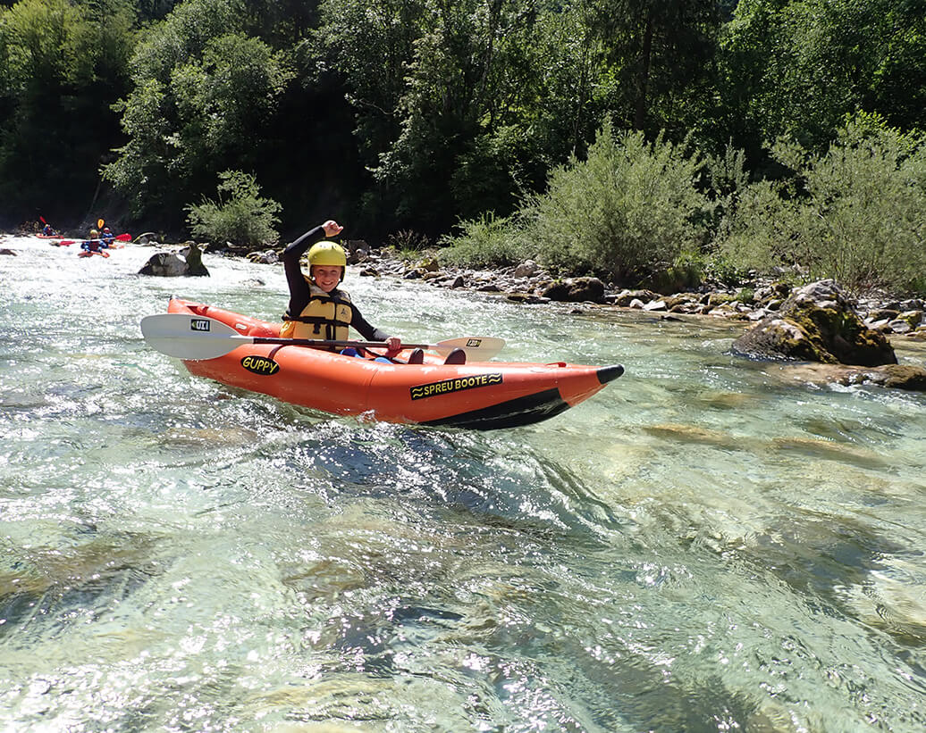 Student is running Soča river on a whitewater kayak tour